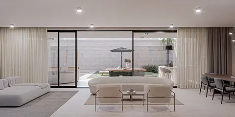 Living integrado ao jardim por grandes portas de vidro